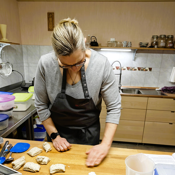 Rebecca formt die Teiglinge, in dem sie den Teig mit der Hand auf dem Tisch rollt.