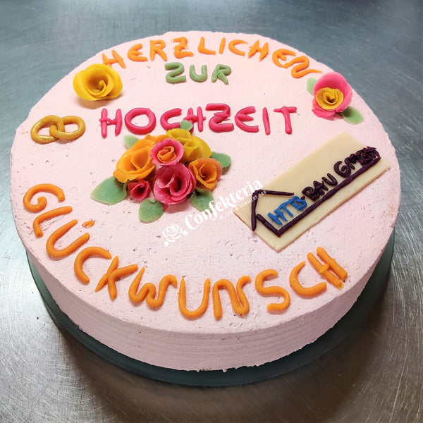 Auf der Torte sind Glückwüsche zur Hochzeit, bunte Rosen, verschlungene Ringe und das Logo einer Firma, die Deko ist aus Marzipan